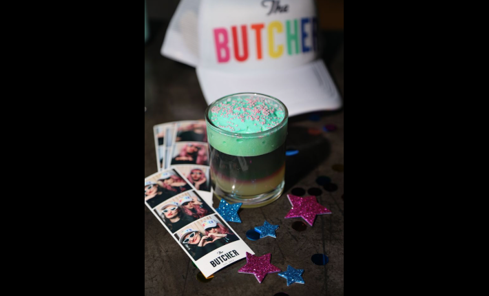 A blue cocktail, a cap and photobooth at THE BUTCHER Social Club