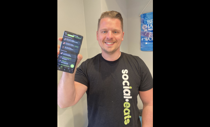 Creator Foster holding the first release of social-eats