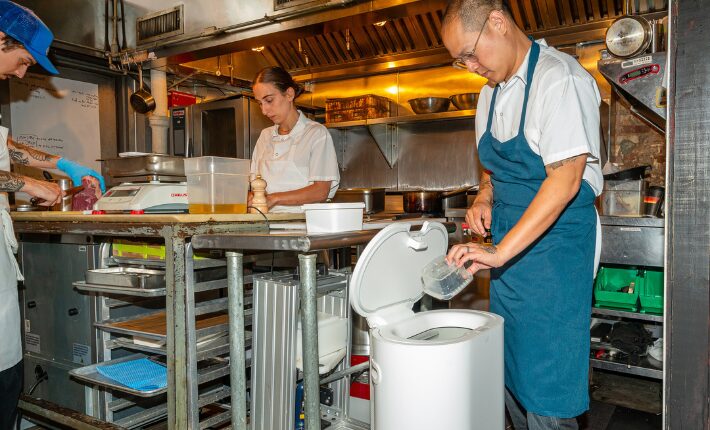 Jeremiah Stone, Chef & Owner of Bar Contra, with a Mill food recycler in the Bar Contra kitchen for Mill's Make Food, Not Waste Restaurant Week